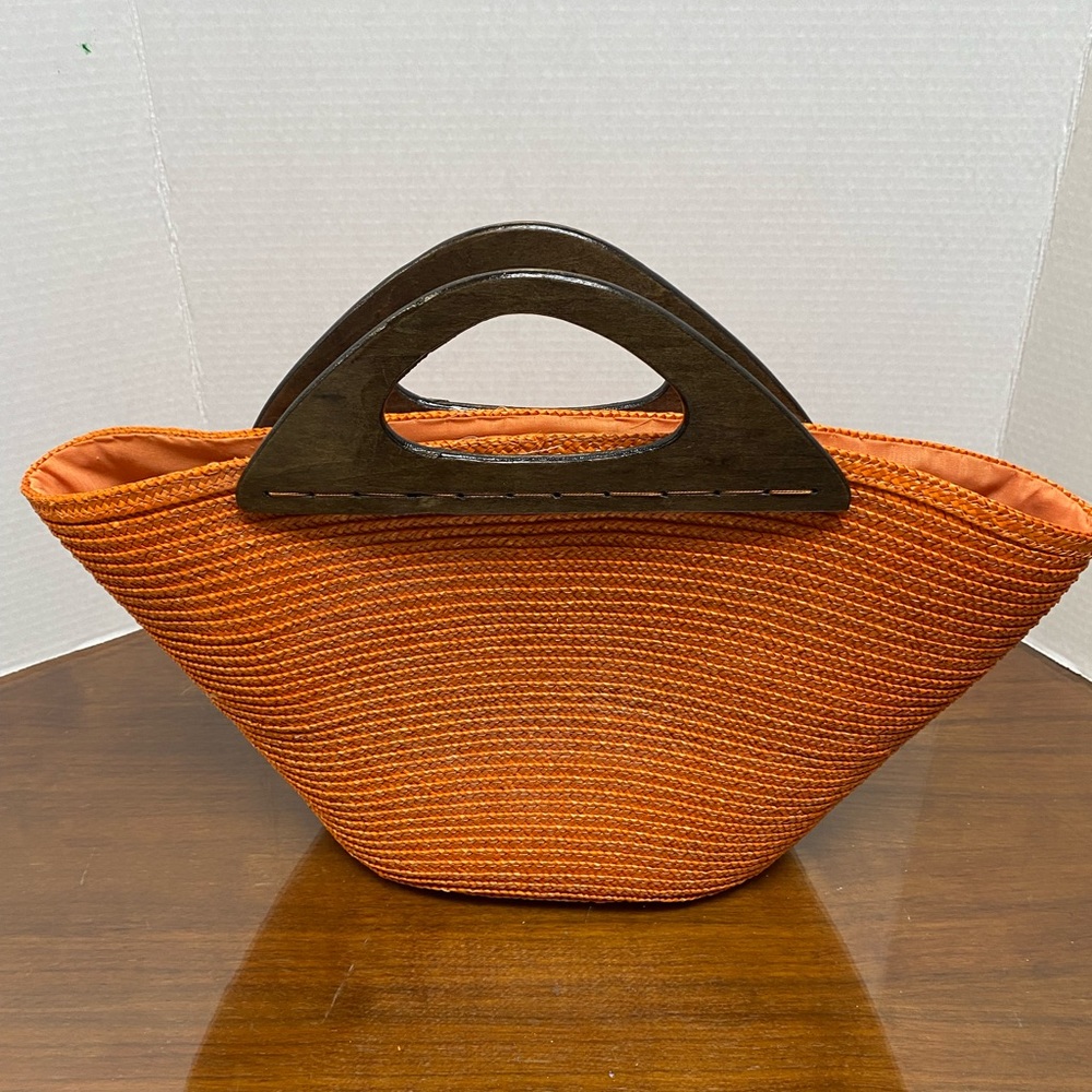 New, Straw clutch handbag. Orange with wood handle.